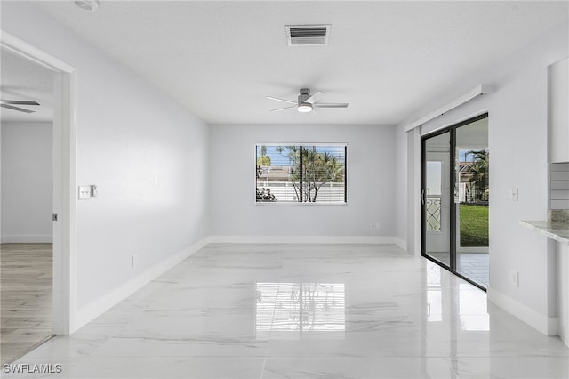 spare room featuring a textured ceiling and ceiling fan