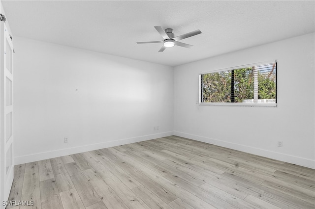 unfurnished room featuring a textured ceiling, light hardwood / wood-style floors, and ceiling fan