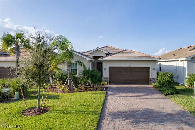 ranch-style house with a garage and a front lawn