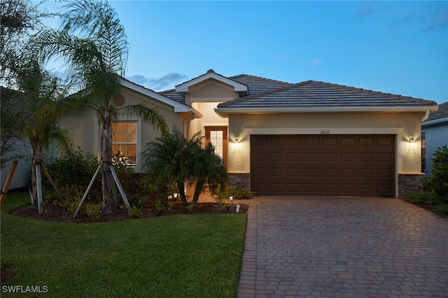 view of front of property with a lawn and a garage