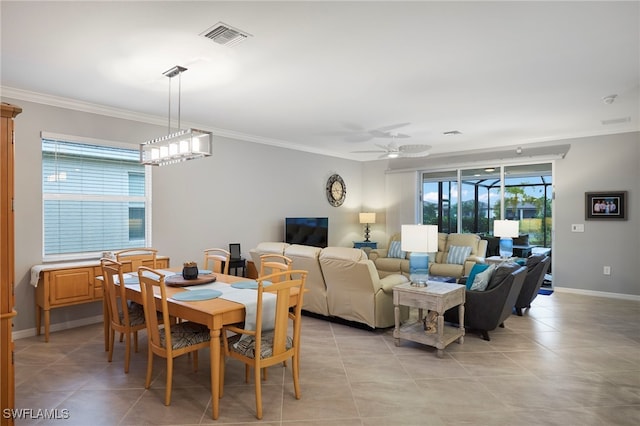 tiled dining area with ornamental molding and ceiling fan