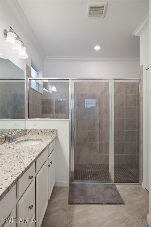 bathroom with crown molding, tile patterned flooring, vanity, and an enclosed shower