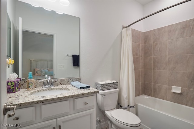 full bathroom with vanity, shower / tub combo, and toilet