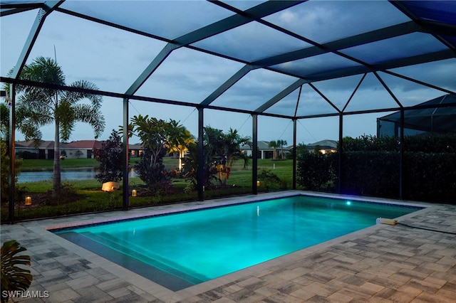 view of swimming pool featuring a lanai, a water view, and a patio