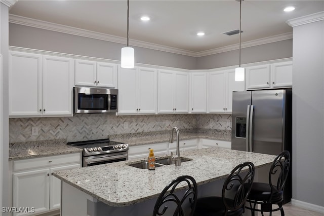 kitchen with white cabinets, stainless steel appliances, hanging light fixtures, and sink