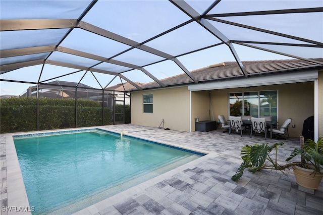 view of pool with a patio and a lanai