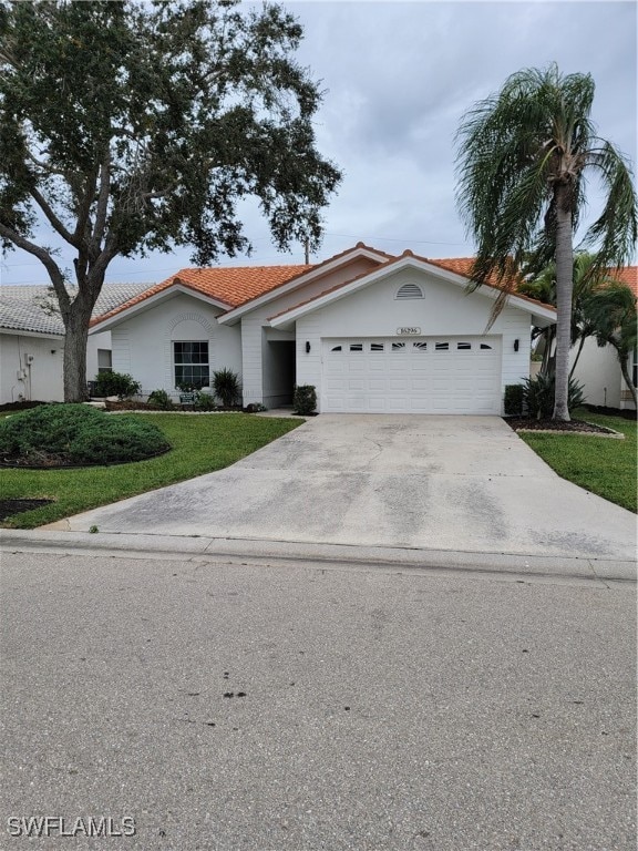 view of front facade featuring a garage and a front lawn