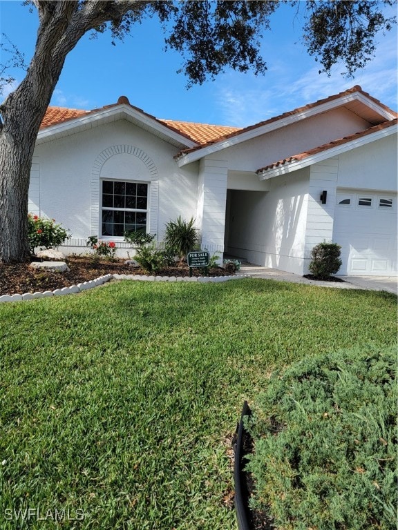 view of front of house with a garage and a front yard