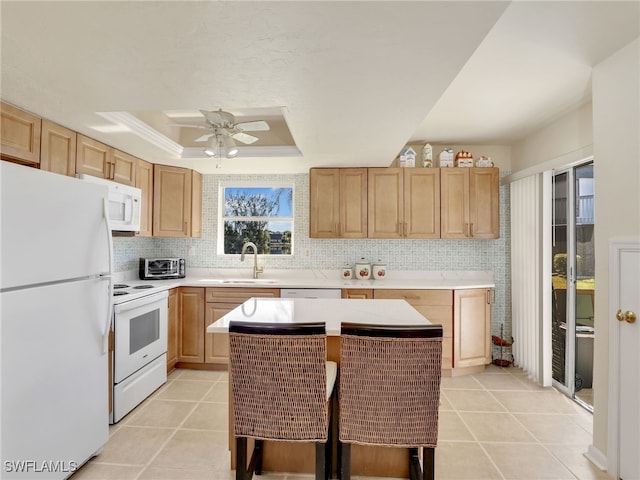 kitchen with white appliances, a center island, plenty of natural light, and sink