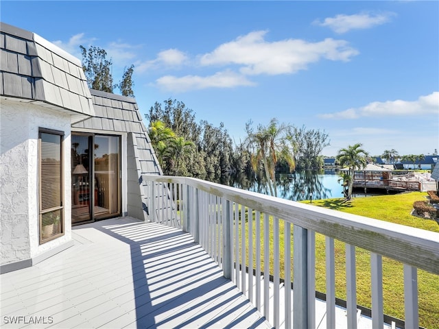 wooden terrace featuring a water view