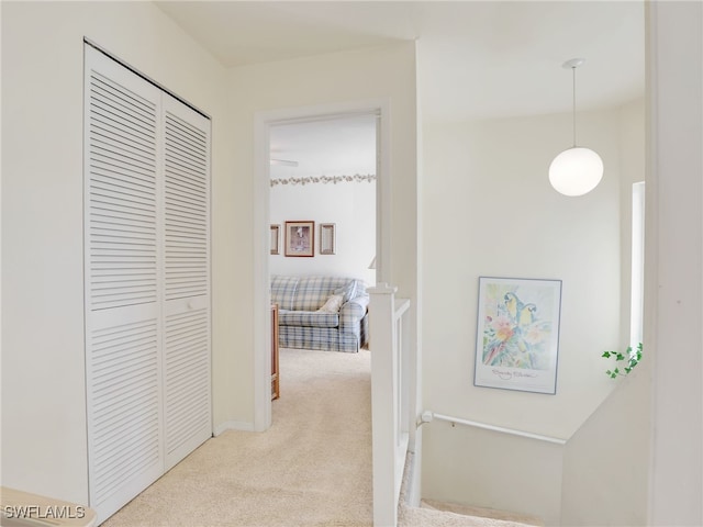 hallway with light colored carpet