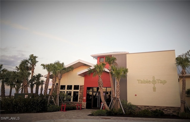 view of outdoor building at dusk