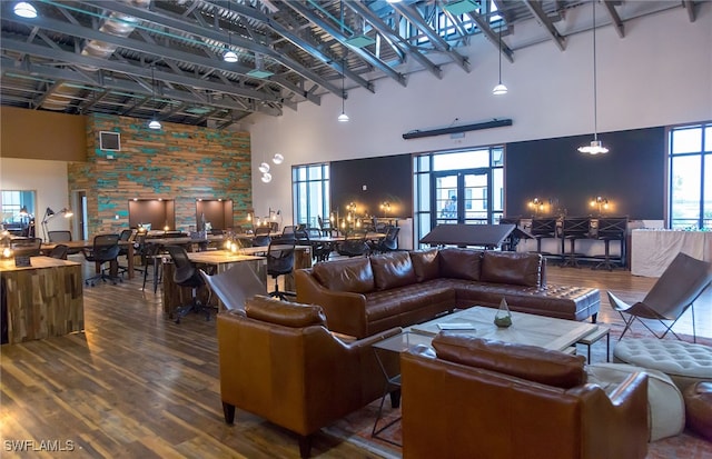 living room with hardwood / wood-style floors, a high ceiling, and french doors