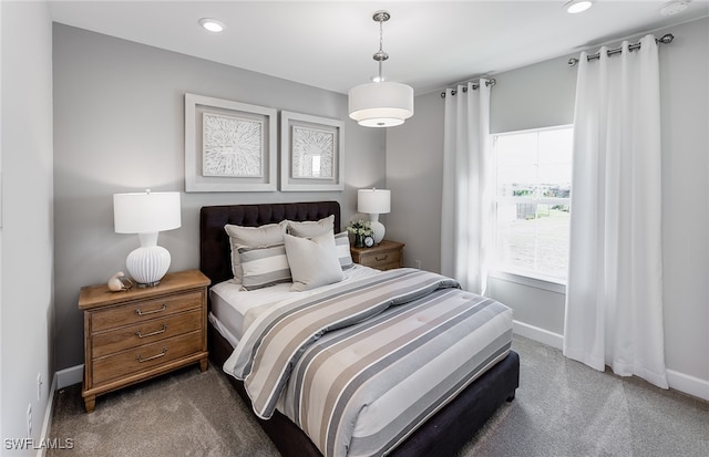 bedroom featuring dark colored carpet