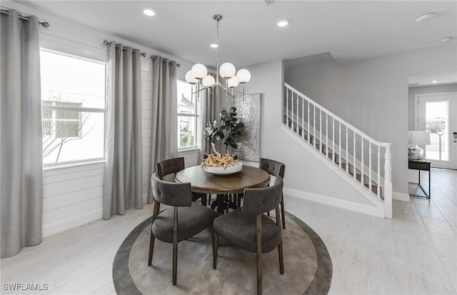 dining room featuring light wood-type flooring and a chandelier