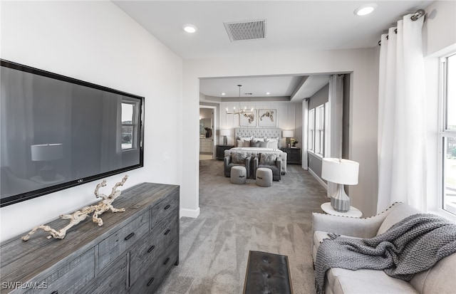 bedroom with a chandelier, multiple windows, and carpet floors