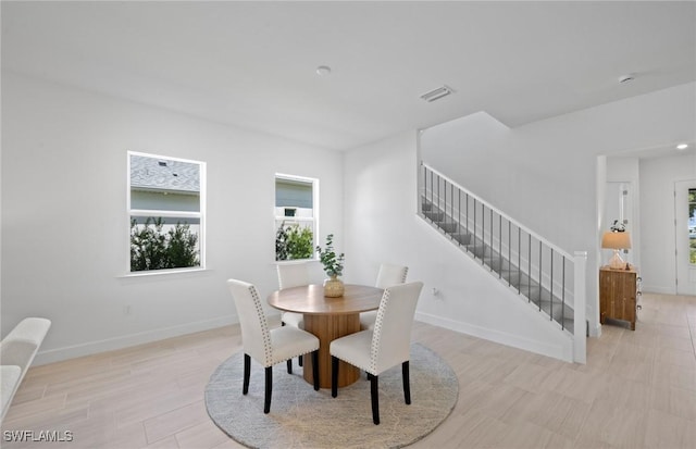 42202 Lake Timber Dr, Punta Gorda, FL 33982 - dining space featuring stairs and light wood-style floors