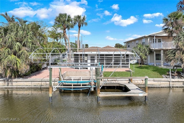 view of dock with a yard and a water view