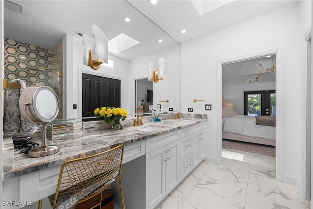 bathroom featuring a skylight and vanity