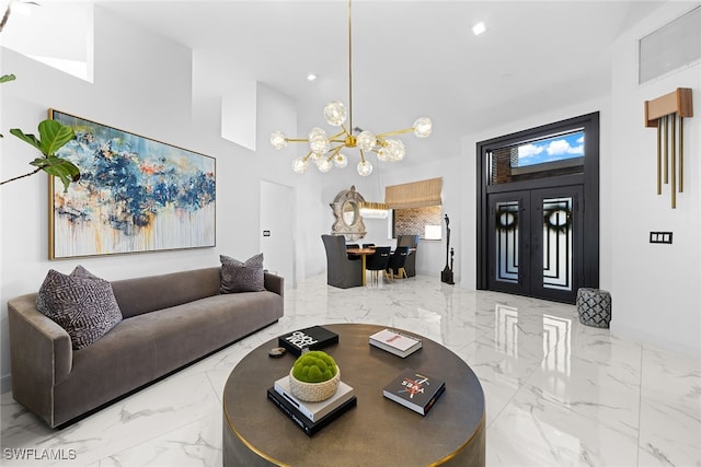 living room with a towering ceiling and an inviting chandelier