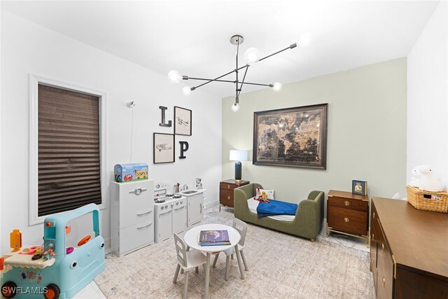 recreation room featuring a chandelier