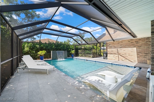 view of swimming pool featuring a patio, pool water feature, and glass enclosure