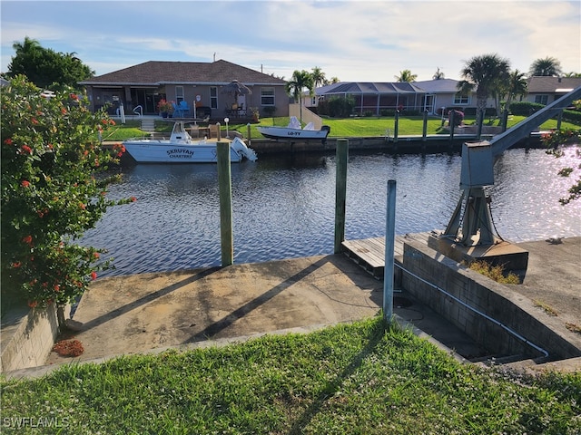 dock area with glass enclosure and a water view