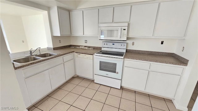 kitchen with white cabinets, white appliances, sink, and light tile patterned flooring