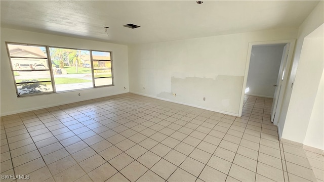 unfurnished room with light tile patterned floors