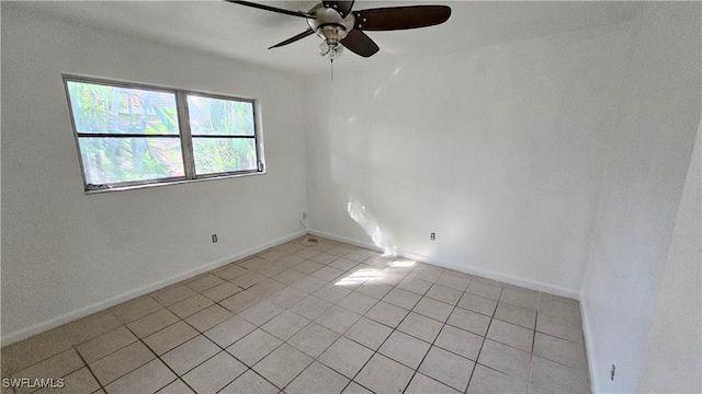 tiled spare room featuring ceiling fan