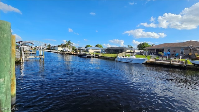 dock area with a lanai and a water view