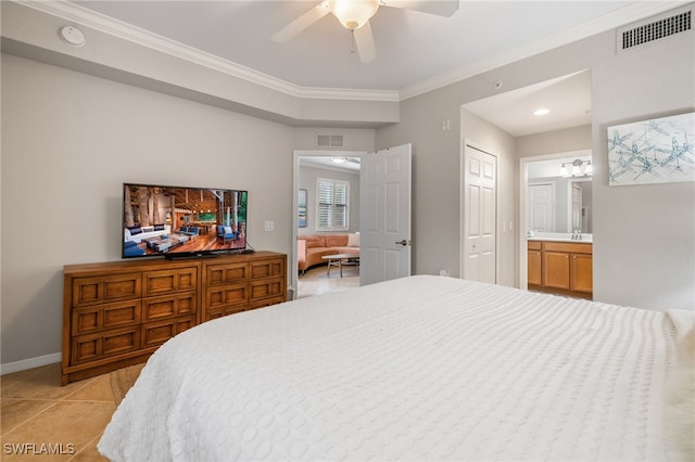 bedroom with light tile patterned flooring, ensuite bath, sink, ceiling fan, and crown molding