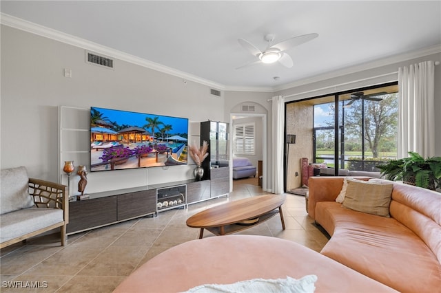 tiled living room with ceiling fan and ornamental molding