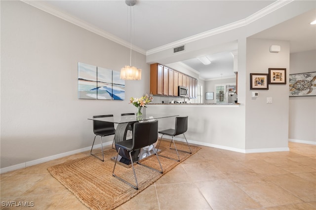 tiled dining area with a chandelier and ornamental molding