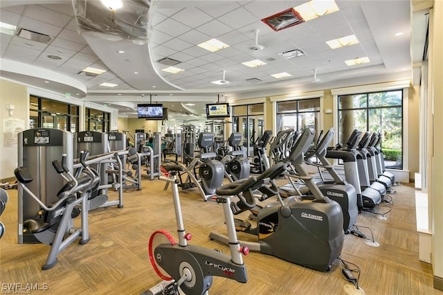 workout area featuring a drop ceiling and light colored carpet