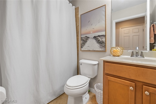 bathroom featuring toilet, vanity, and tile patterned floors