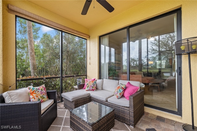 sunroom featuring ceiling fan