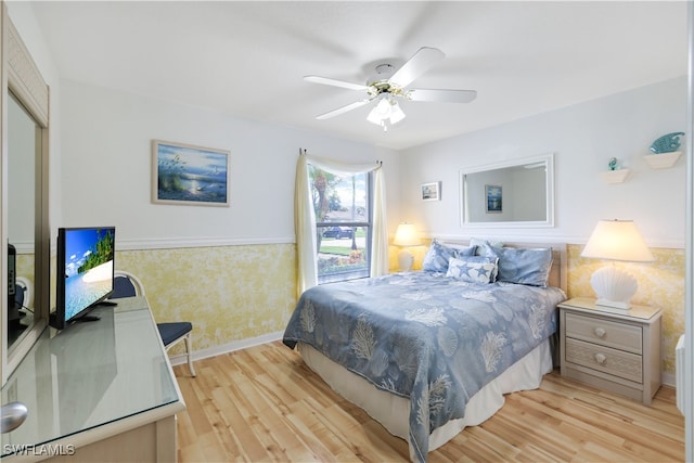 bedroom with light hardwood / wood-style floors and ceiling fan