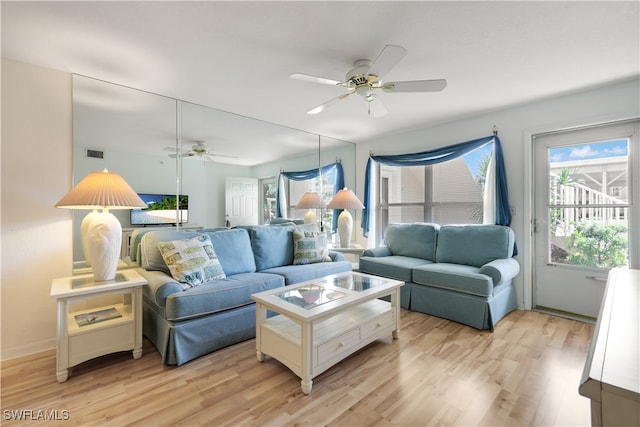 living room featuring light hardwood / wood-style floors and ceiling fan