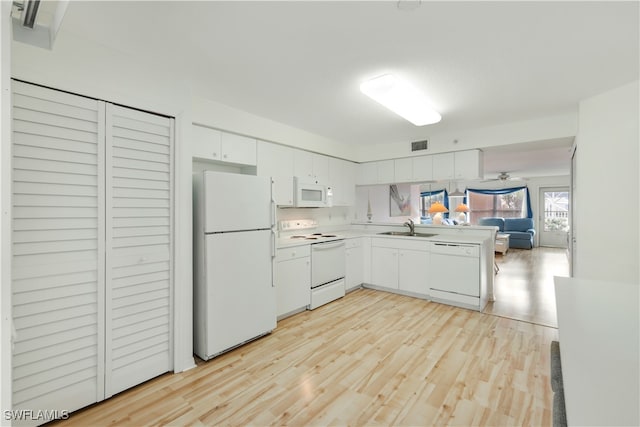 kitchen featuring white cabinetry, sink, ceiling fan, white appliances, and light wood-type flooring