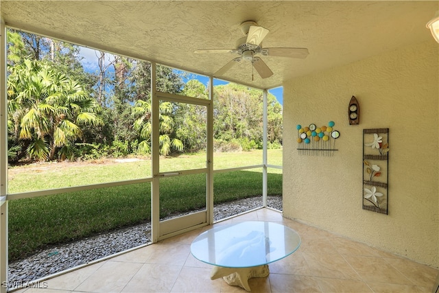 unfurnished sunroom featuring ceiling fan