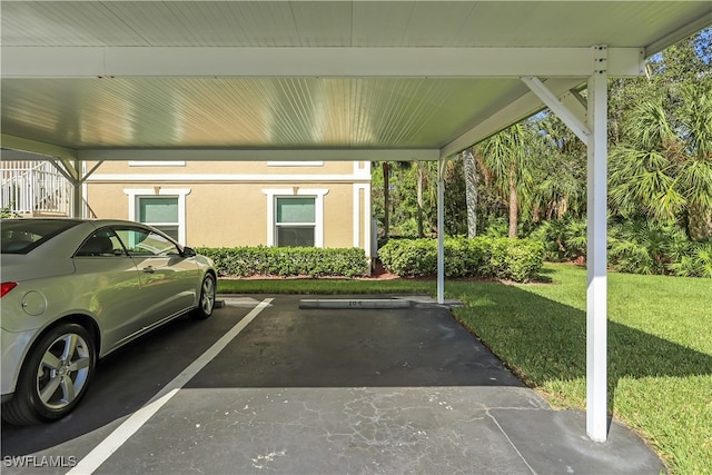 view of vehicle parking with a lawn