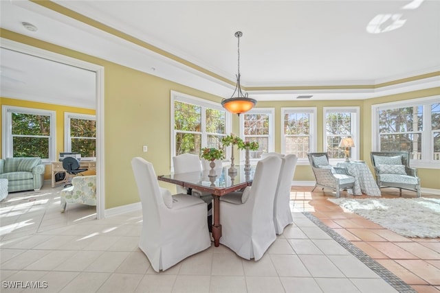 tiled dining room with crown molding and a healthy amount of sunlight