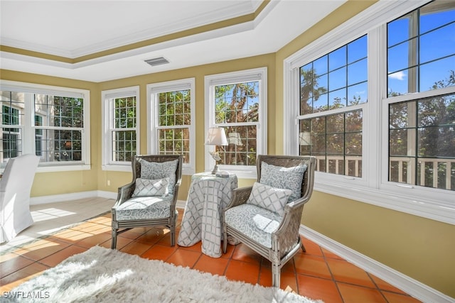 sunroom featuring a raised ceiling