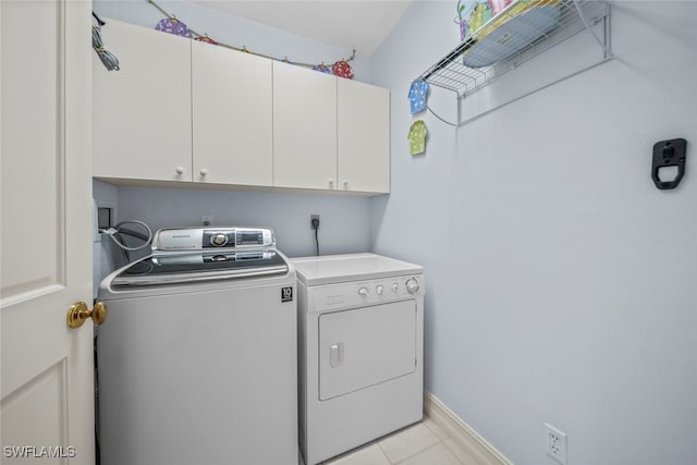 washroom with cabinets and independent washer and dryer