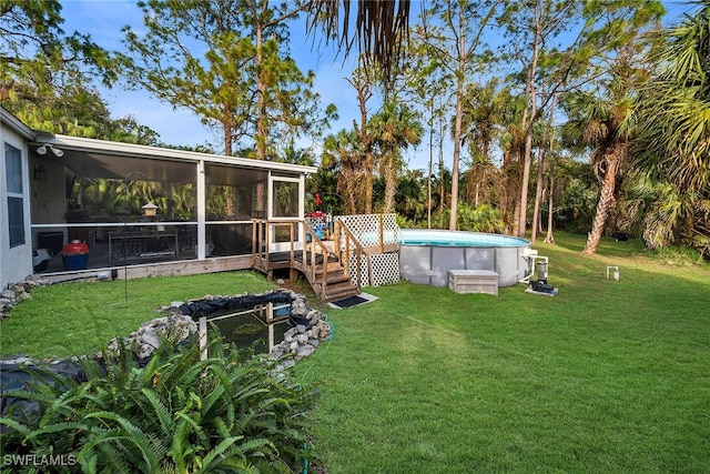 view of yard featuring a sunroom and a swimming pool side deck