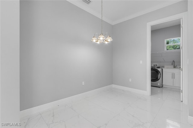 spare room featuring a chandelier, washer / dryer, and crown molding