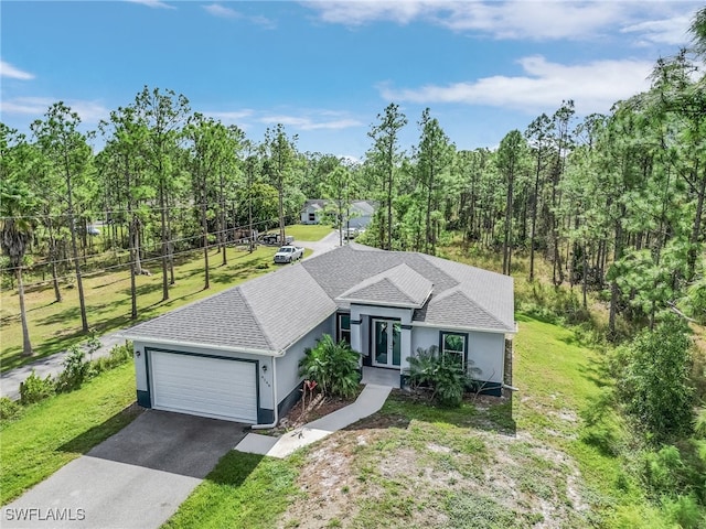 view of front of property with a front lawn and a garage