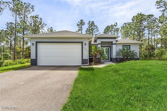 view of front of home with a front lawn and a garage