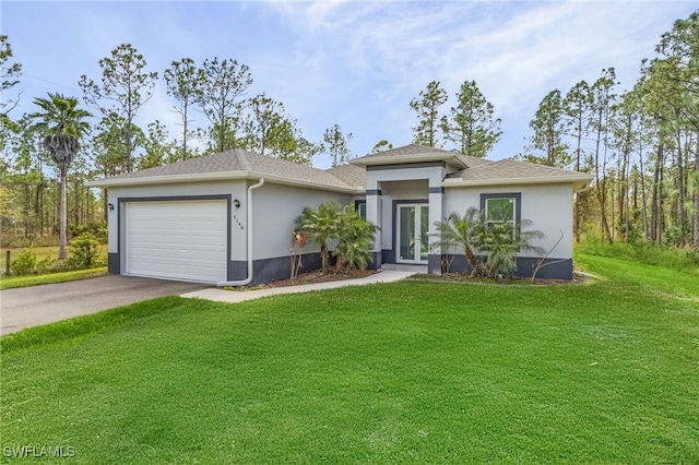 view of front of home featuring a front lawn and a garage